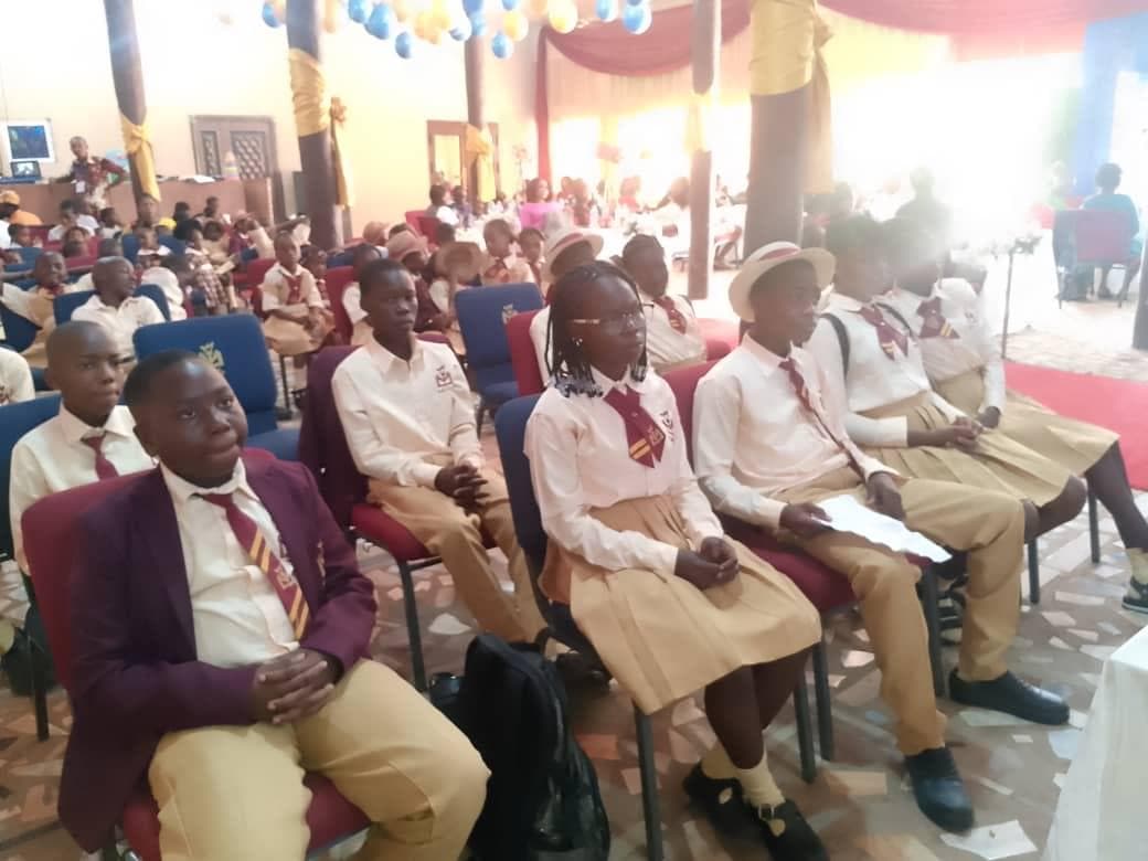 Sacred Harvesters students seated together for a school assembly